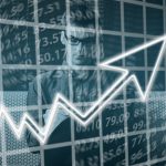 A man behind a glowing upward-trending arrow and a grid of financial numbers, symbolizing financial growth and strategies to boost credit score.