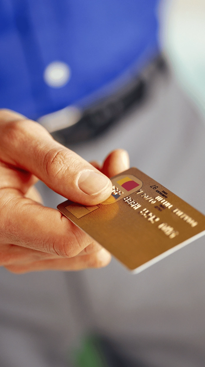 A person holding a gold credit card illustrating business tradelines for sale.
