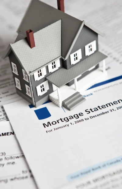 A small model house sitting on top of a mortgage statement document often associated with CPN number queries.